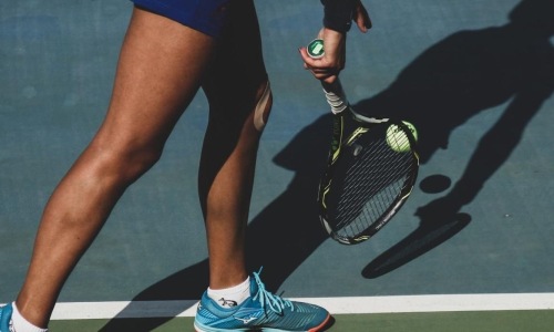 Settle into comfort at The Stafford a person holding a tennis racket