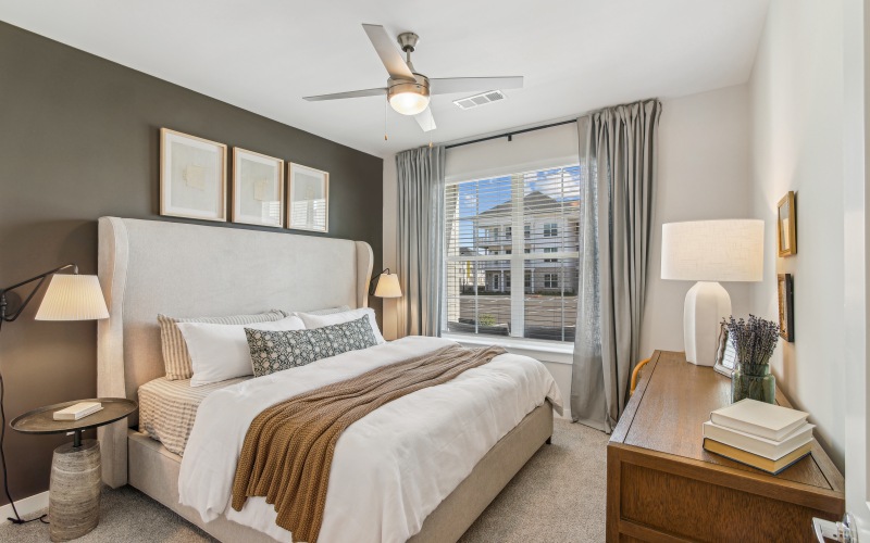 bedroom with a dresser and fan ceiling light